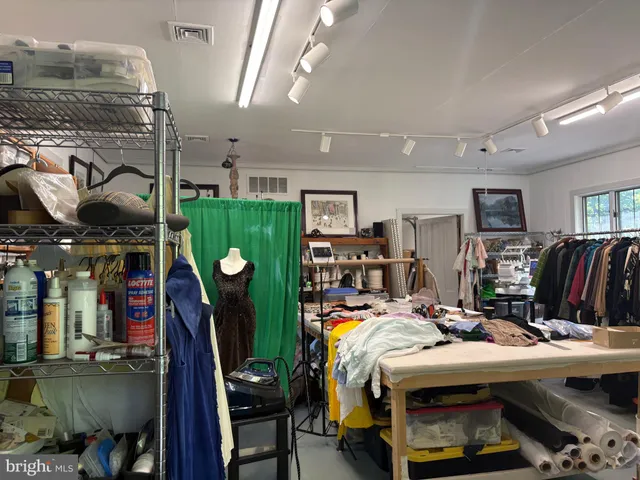 a bed room with a bed and a computer on a desk