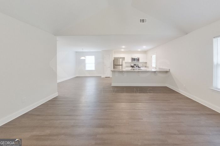 231 Western Red Cedar Drive Springfield, GA 31329 - Photo 4 of 26 a view of a kitchen with wooden floor and a window