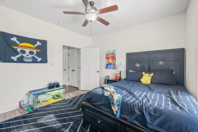 a bedroom with a bed and a chandelier