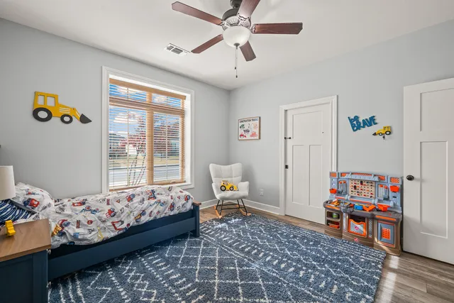 a bedroom with furniture and a book shelf