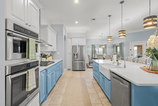 a large kitchen with stainless steel appliances granite countertop a stove a sink and a refrigerator