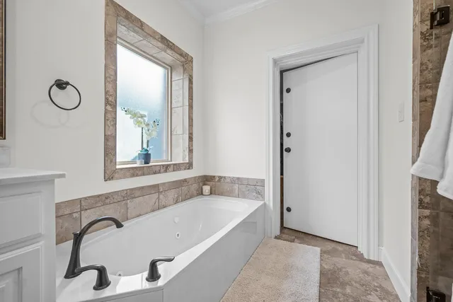 a bathroom with a tub and a window