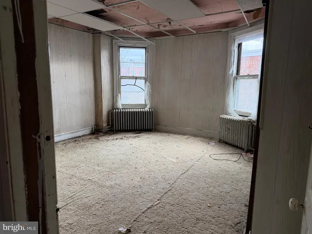 a view of an empty room and a window