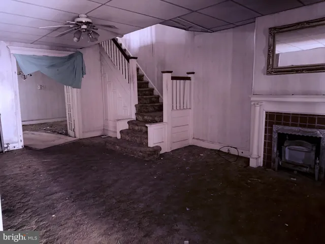 a view of a livingroom with fireplace and hardwood floor