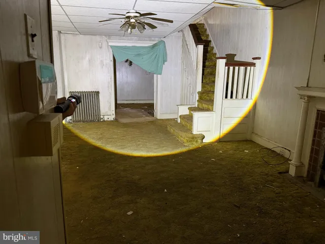 a view of a livingroom with furniture and staircase