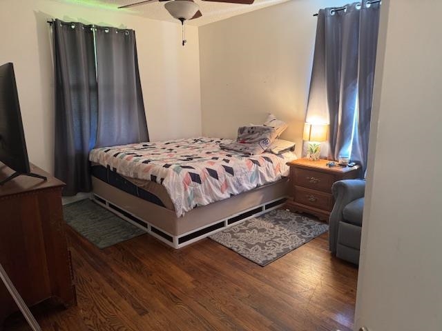 1345 Maria Street Memphis, TN 38122 - Photo 5 of 11 a bedroom with a bed a window and wooden floor