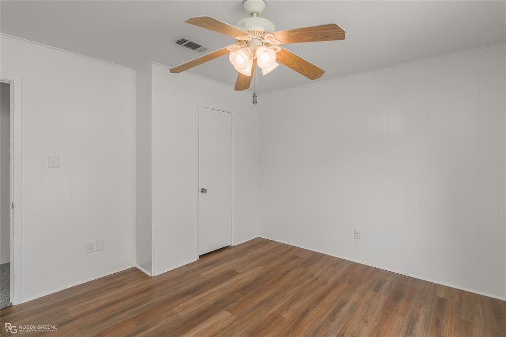 1303 Young Road Benton, LA 71006 - Photo 23 of 34 Spare room featuring ornamental molding, dark wood-style flooring, and a ceiling fan
