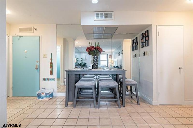 101 South Raleigh Avenue, Unit 625 Atlantic City, NJ 08401 - Photo 4 of 15 a dining room with furniture and a chandelier