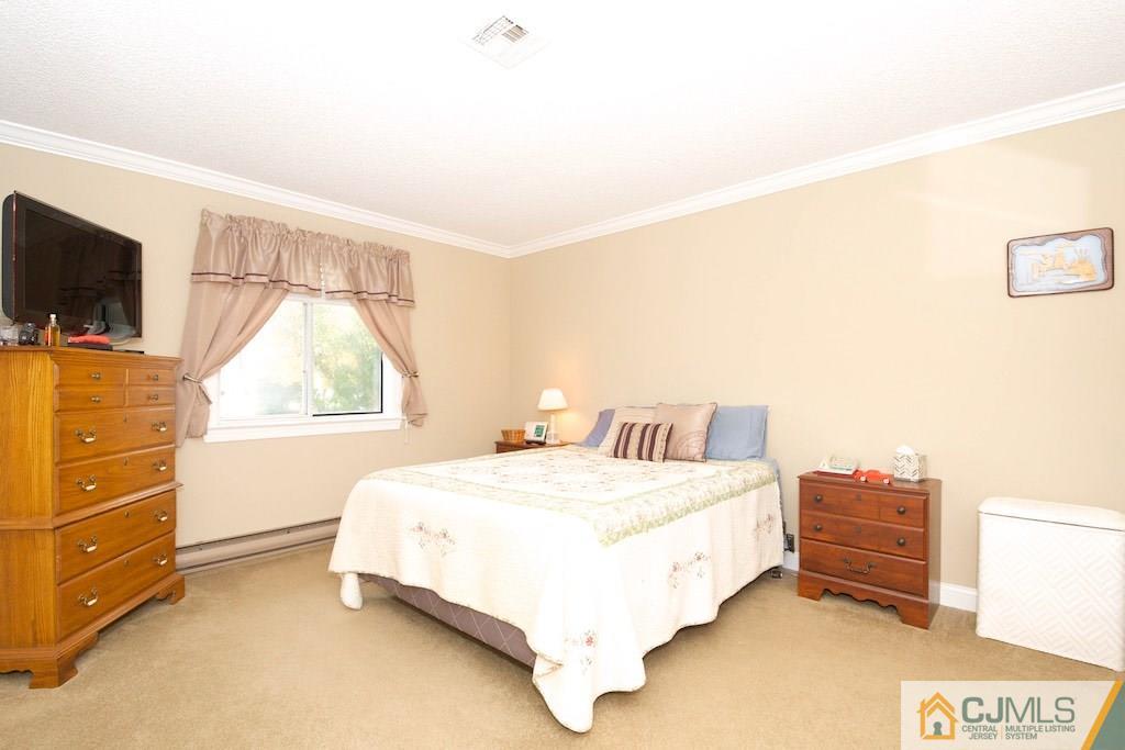 781 B Risley Road Monroe Township, NJ 08831 - Photo 11 of 20 a bedroom with a bed and a flat screen tv