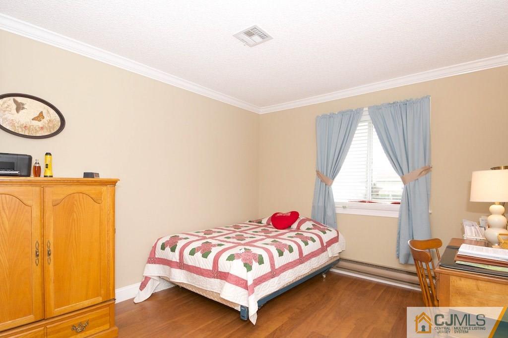 781 B Risley Road Monroe Township, NJ 08831 - Photo 14 of 20 a bedroom with a bed and window