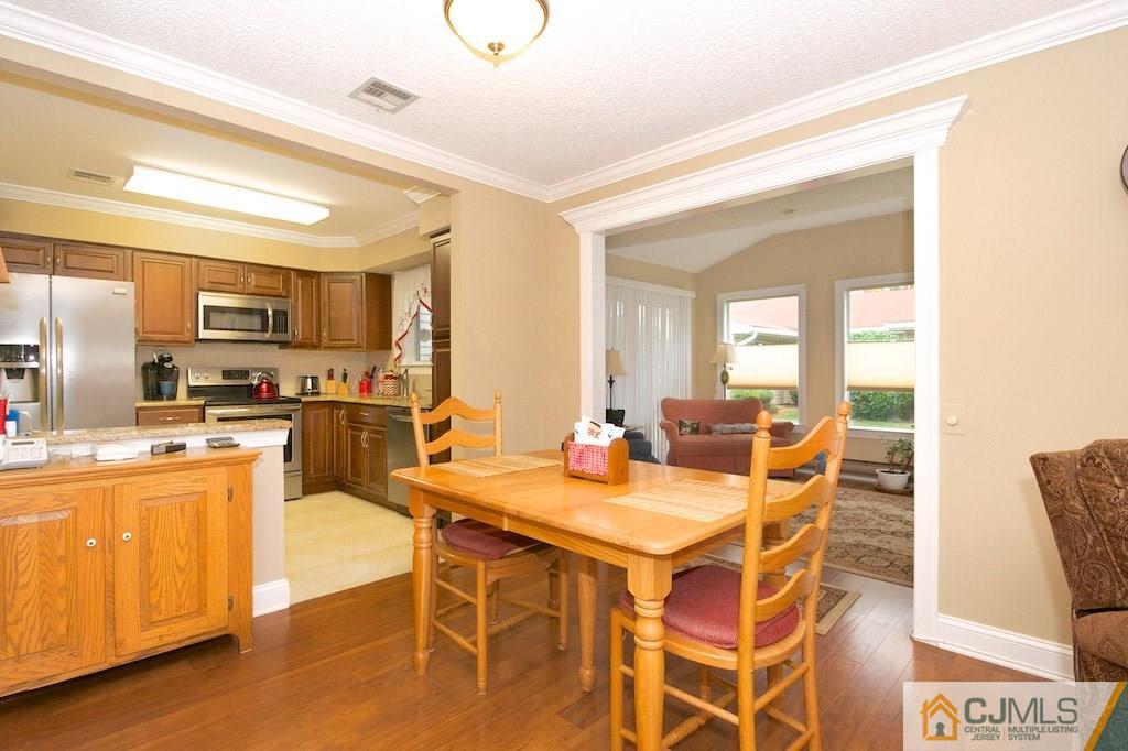 781 B Risley Road Monroe Township, NJ 08831 - Photo 6 of 20 a view of a dining room with furniture and wooden floor