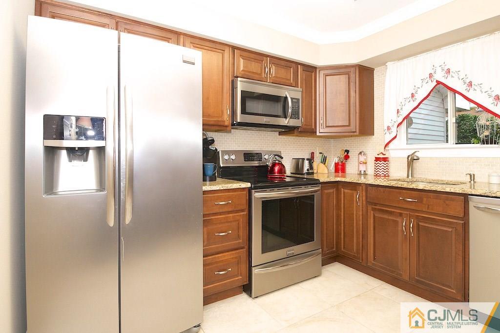 781 B Risley Road Monroe Township, NJ 08831 - Photo 7 of 20 a kitchen with stainless steel appliances granite countertop a refrigerator and a sink