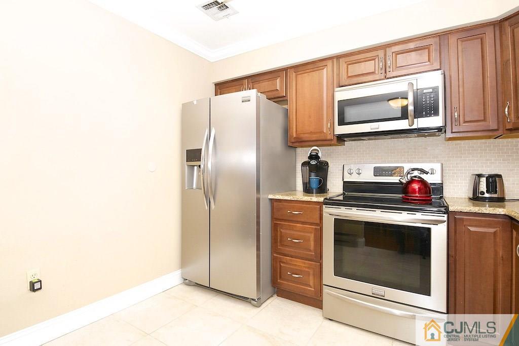 781 B Risley Road Monroe Township, NJ 08831 - Photo 8 of 20 a kitchen with stainless steel appliances granite countertop a refrigerator stove and sink