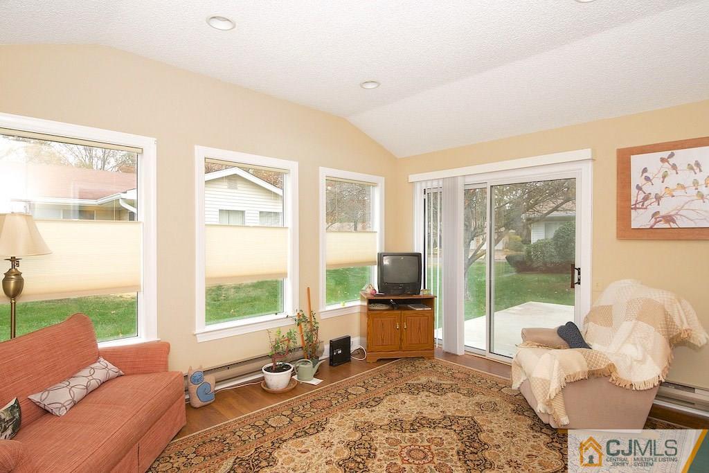 781 B Risley Road Monroe Township, NJ 08831 - Photo 9 of 20 a living room with furniture floor to ceiling windows and a floor to ceiling window