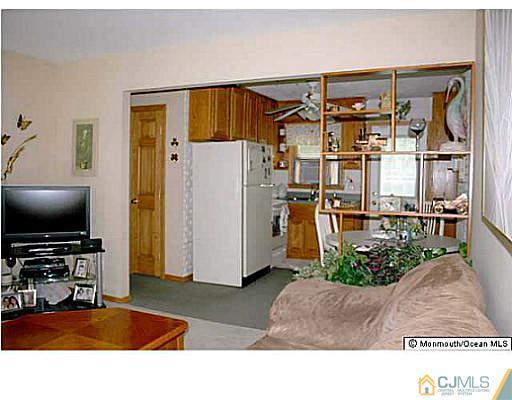 502 Harding Road Old Bridge, NJ 08879 - Photo 4 of 11 a living room with furniture and a flat screen tv