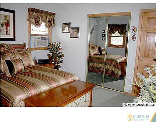 502 Harding Road Old Bridge, NJ 08879 - Photo 6 of 11 a bedroom with a bed and a mirror