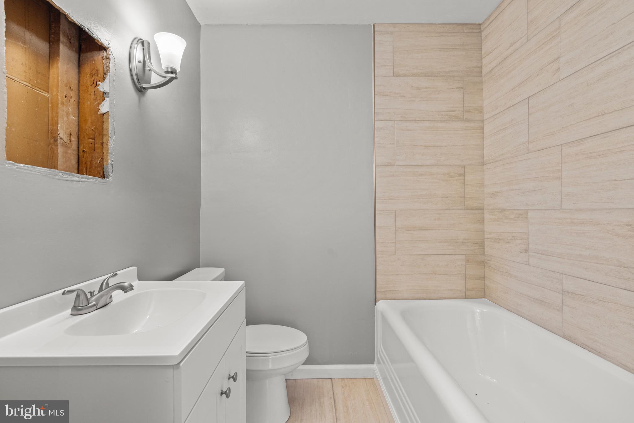 2834 R Street Southeast, Unit 5 Washington, DC 20020 - Photo 11 of 30 a bathroom with a sink a toilet and shower