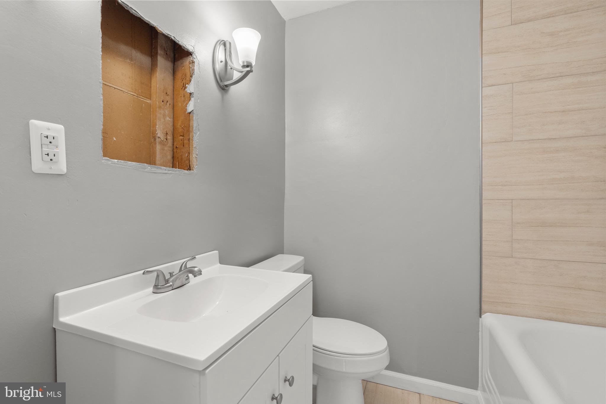 2834 R Street Southeast, Unit 5 Washington, DC 20020 - Photo 12 of 30 a bathroom with a sink a toilet and mirror