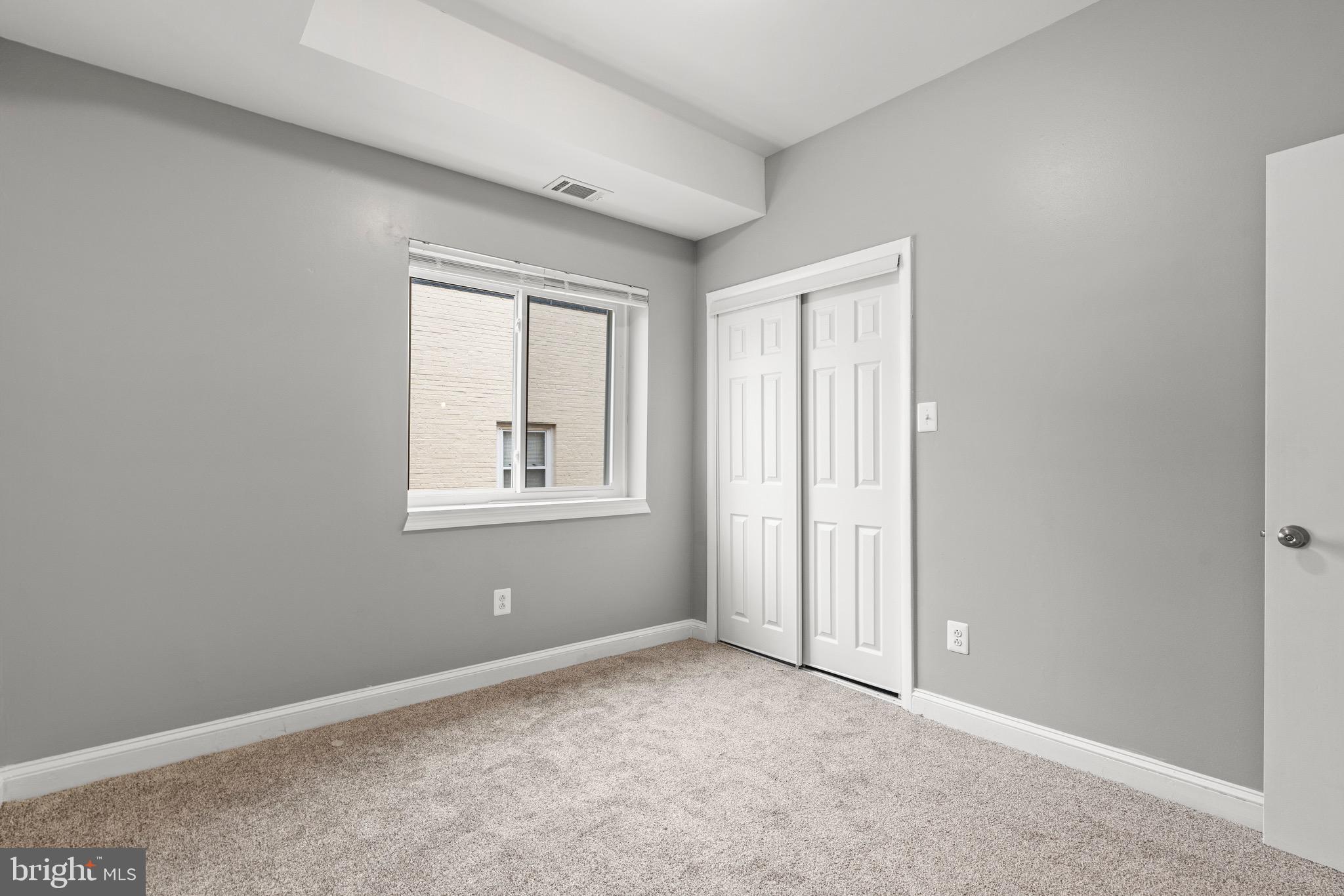 2834 R Street Southeast, Unit 5 Washington, DC 20020 - Photo 20 of 30 an empty room with windows and closet