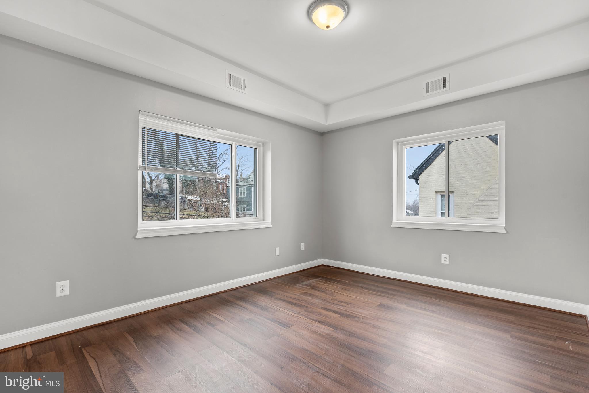 2834 R Street Southeast, Unit 5 Washington, DC 20020 - Photo 23 of 30 a view of an empty room with wooden floor and a window
