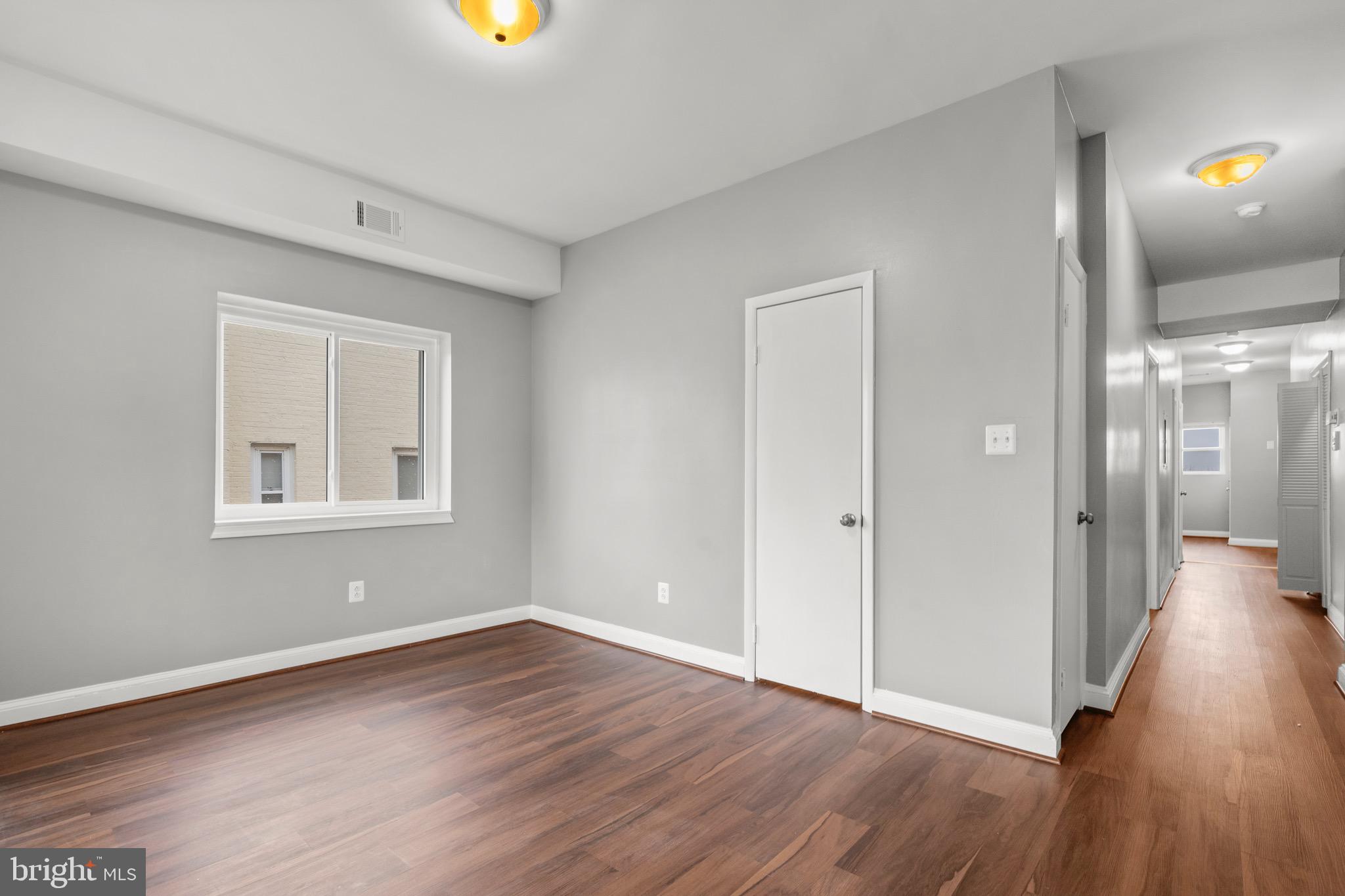 2834 R Street Southeast, Unit 5 Washington, DC 20020 - Photo 24 of 30 a view of an empty room with wooden floor and a window