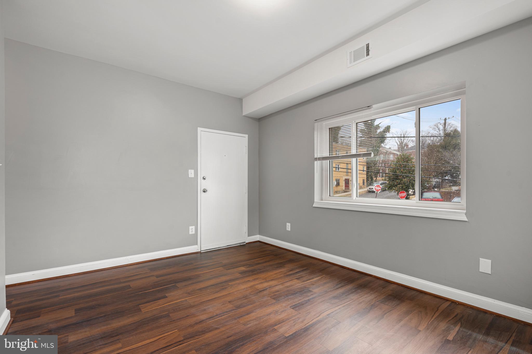 2834 R Street Southeast, Unit 5 Washington, DC 20020 - Photo 26 of 30 a view of an empty room with wooden floor and a window