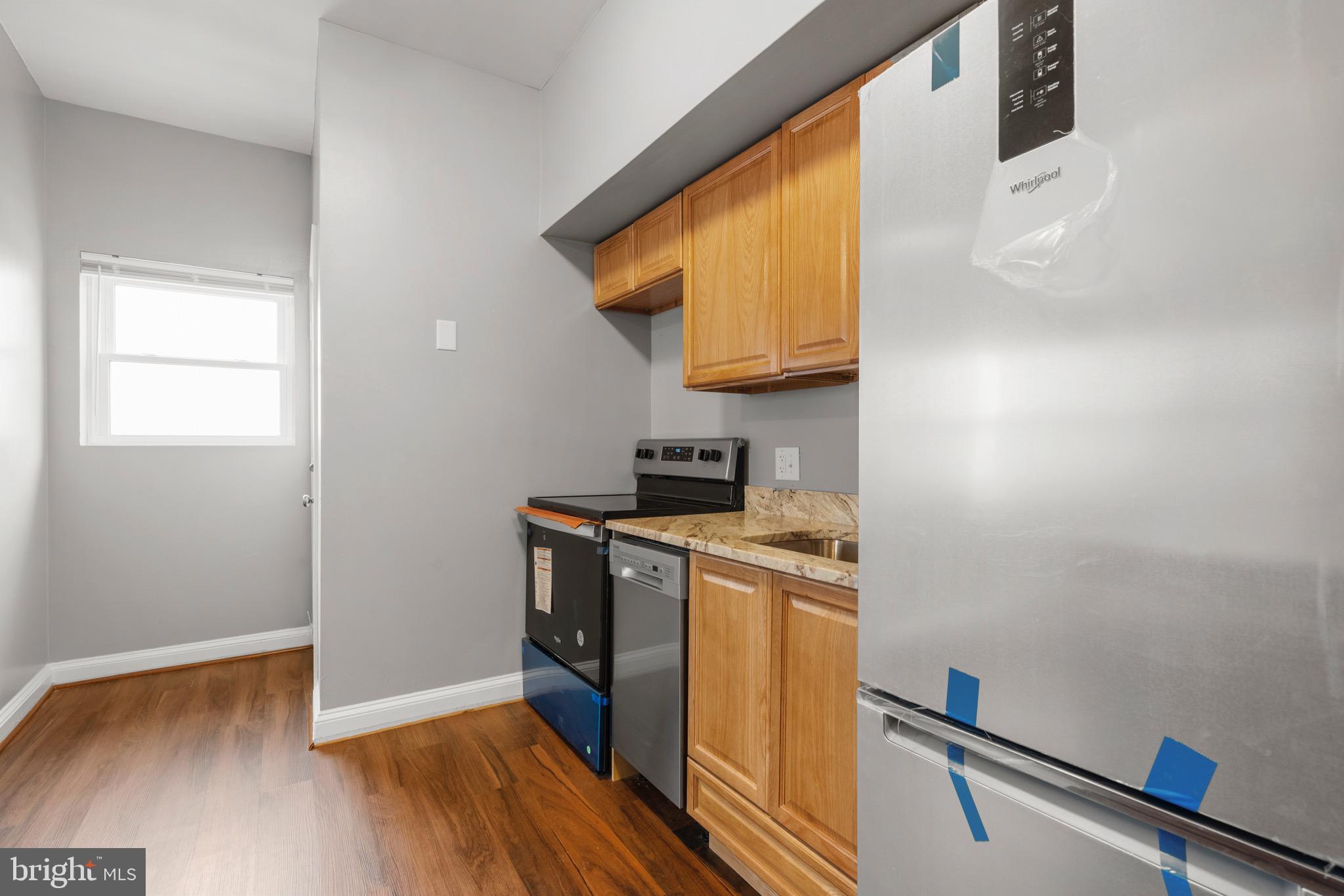 2834 R Street Southeast, Unit 5 Washington, DC 20020 - Photo 3 of 30 a view of a kitchen with wooden floor and a sink