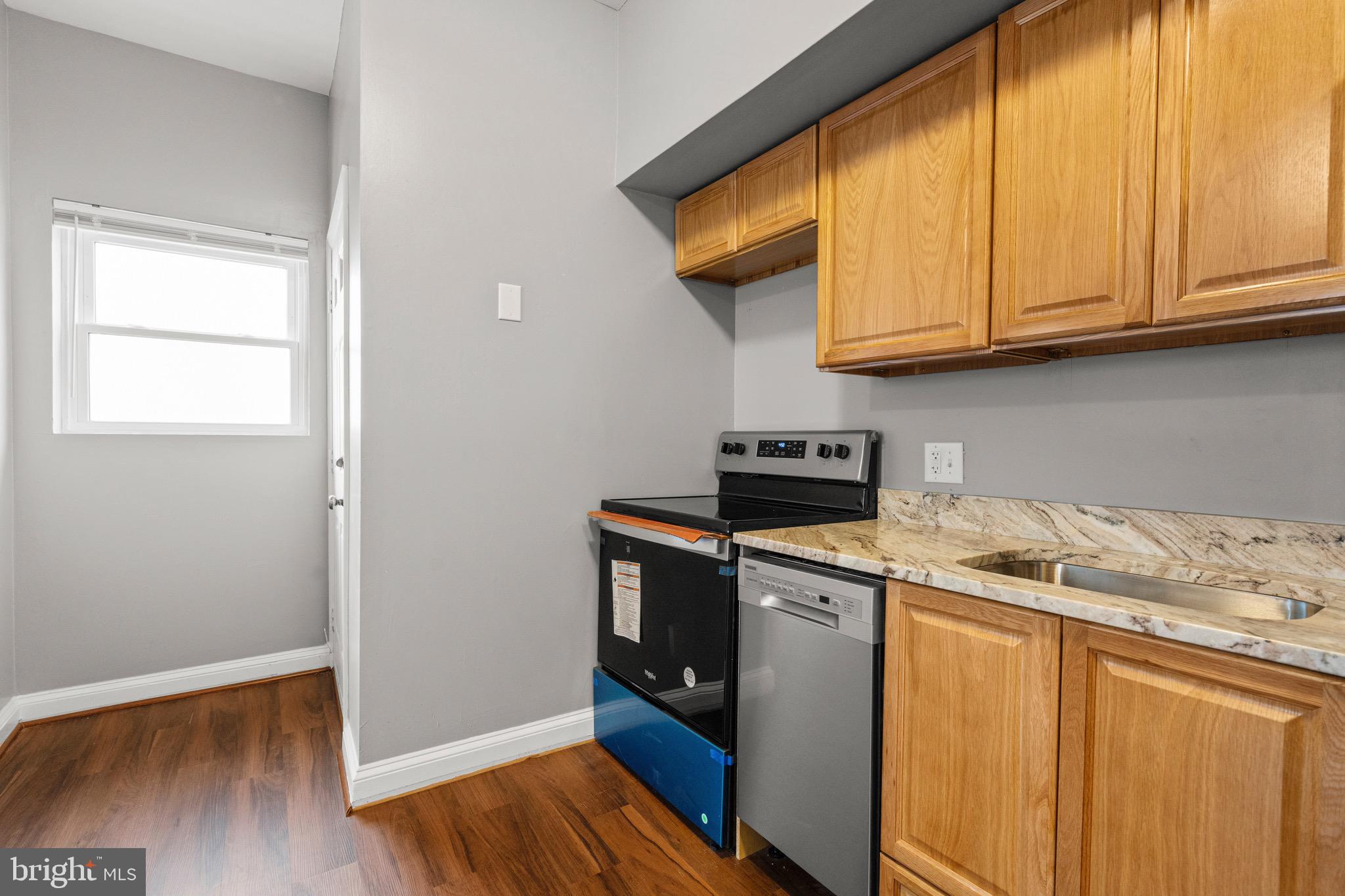 2834 R Street Southeast, Unit 5 Washington, DC 20020 - Photo 4 of 30 a kitchen with stainless steel appliances granite countertop a sink and a cabinets