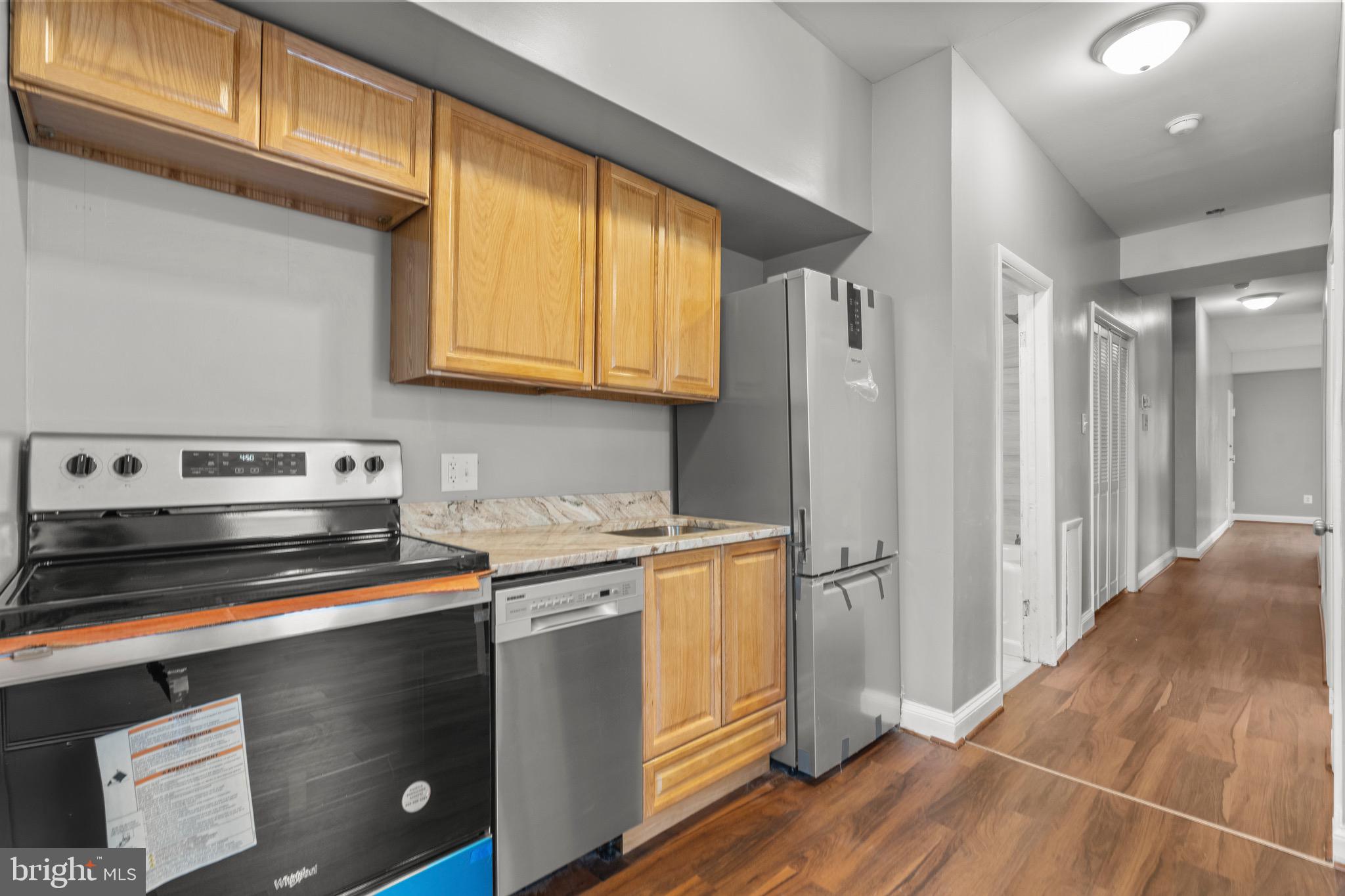 2834 R Street Southeast, Unit 5 Washington, DC 20020 - Photo 5 of 30 a kitchen with stainless steel appliances granite countertop a refrigerator and a stove