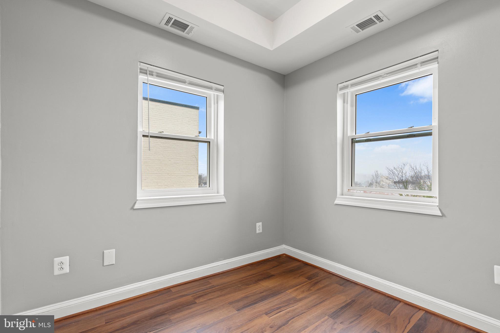 2834 R Street Southeast, Unit 5 Washington, DC 20020 - Photo 8 of 30 a view of an empty room with wooden floor and a window