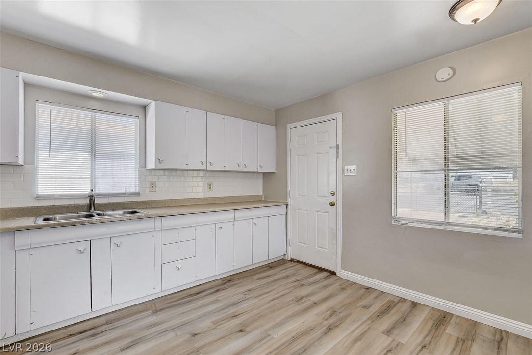 214 West Victory Road Henderson, NV 89015 - Photo 7 of 33 A well-lit kitchen with ample cabinet space and Luxury Vinyl flooring awaits culinary creativity.