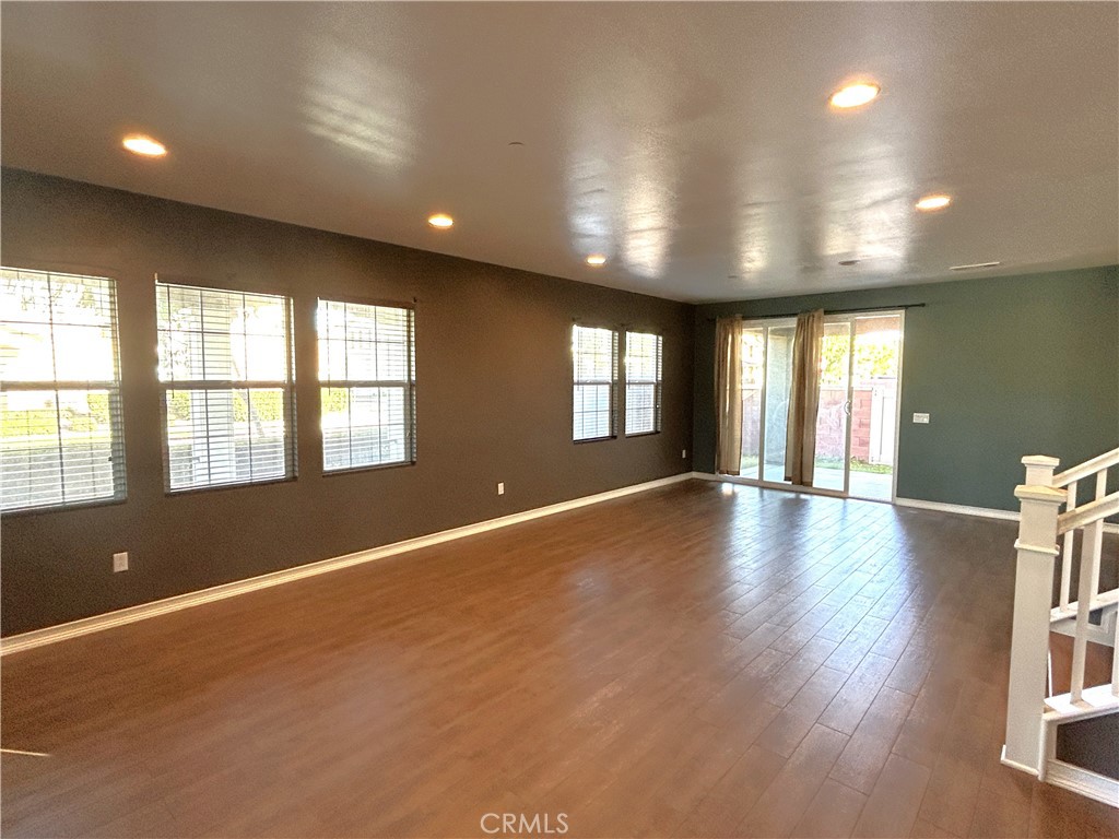 16051 Nature Chino, CA 91708 - Photo 5 of 41 an empty room with wooden floor and windows