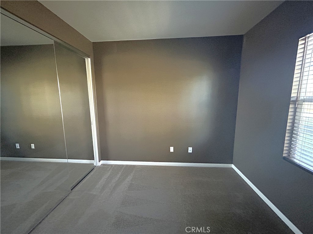 16051 Nature Chino, CA 91708 - Photo 8 of 41 an empty room with windows and closet