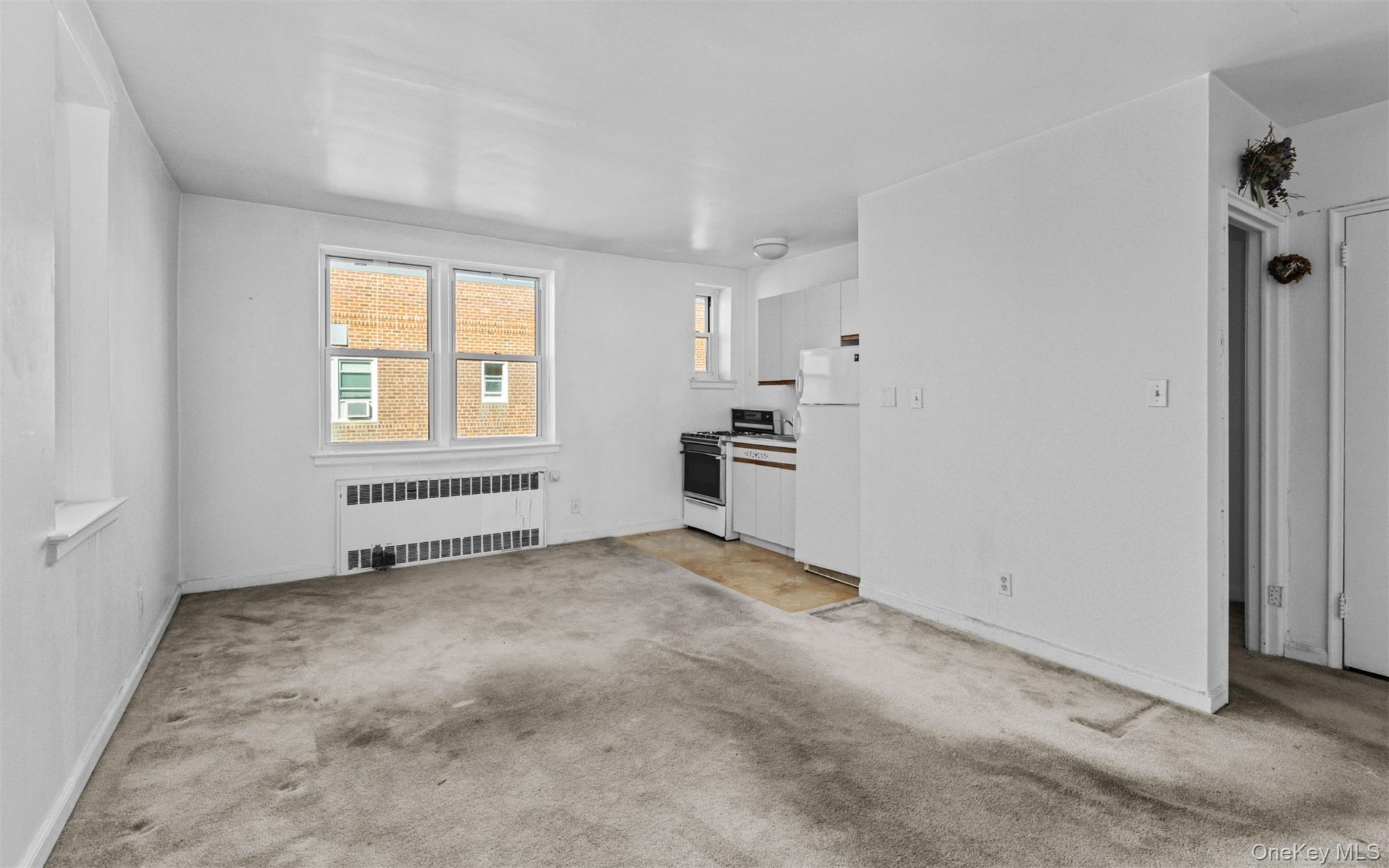 32 Cathedral Avenue, Unit 6C Hempstead, NY 11550 - Photo 6 of 14 an empty room with windows