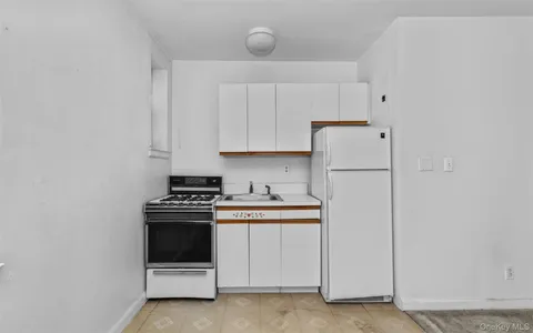 a kitchen with cabinets appliances and a sink