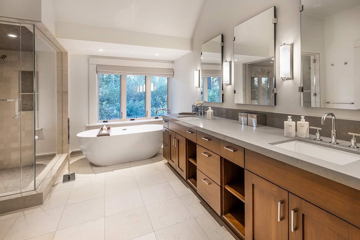 8262 Valhalla Drive Truckee, CA 96161 - Photo 11 of 21 a spacious bathroom with a double vanity sink a mirror and a bathtub