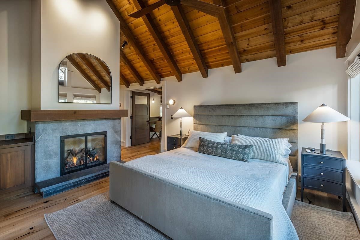 8262 Valhalla Drive Truckee, CA 96161 - Photo 13 of 21 a bedroom with a bed and a fireplace