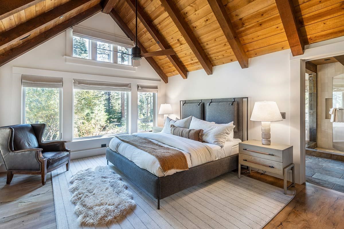 8262 Valhalla Drive Truckee, CA 96161 - Photo 19 of 21 a bedroom with a large bed and a large window with couch