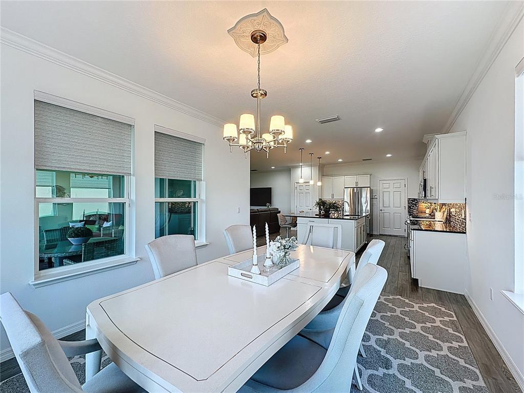 178 Silver Maple Road Groveland, FL 34736 - Photo 17 of 72 a view of a dining room with furniture and a chandelier