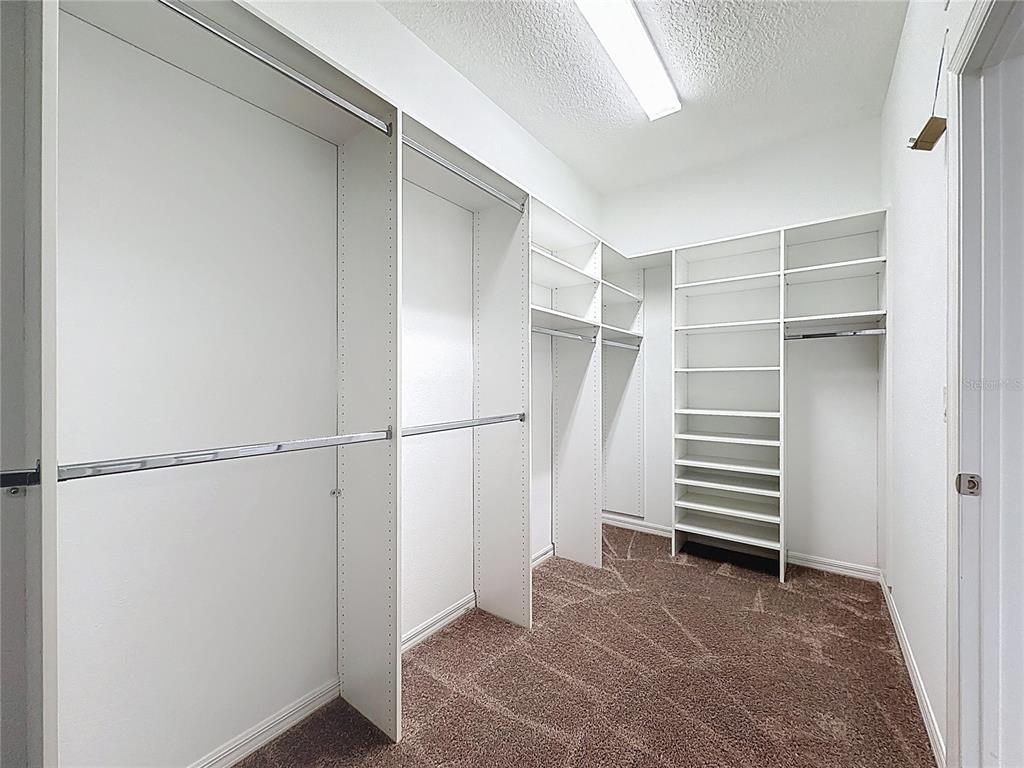 178 Silver Maple Road Groveland, FL 34736 - Photo 22 of 72 a view of walk in closet with empty racks
