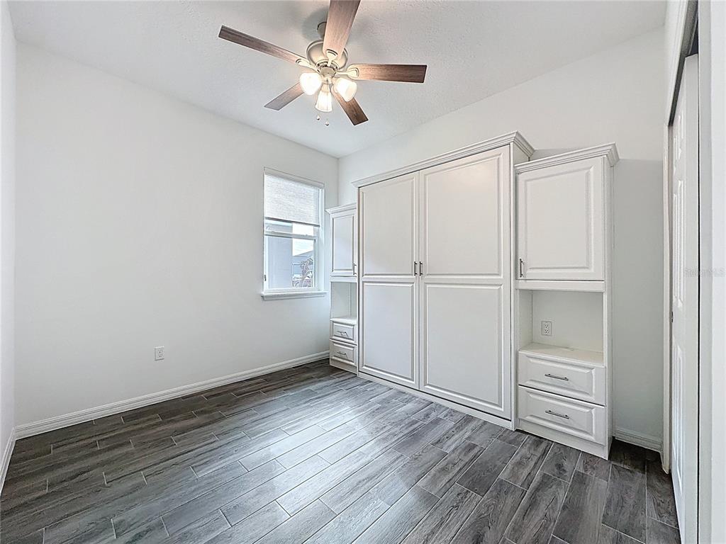 178 Silver Maple Road Groveland, FL 34736 - Photo 27 of 72 a view of an empty room with a window and wooden floor