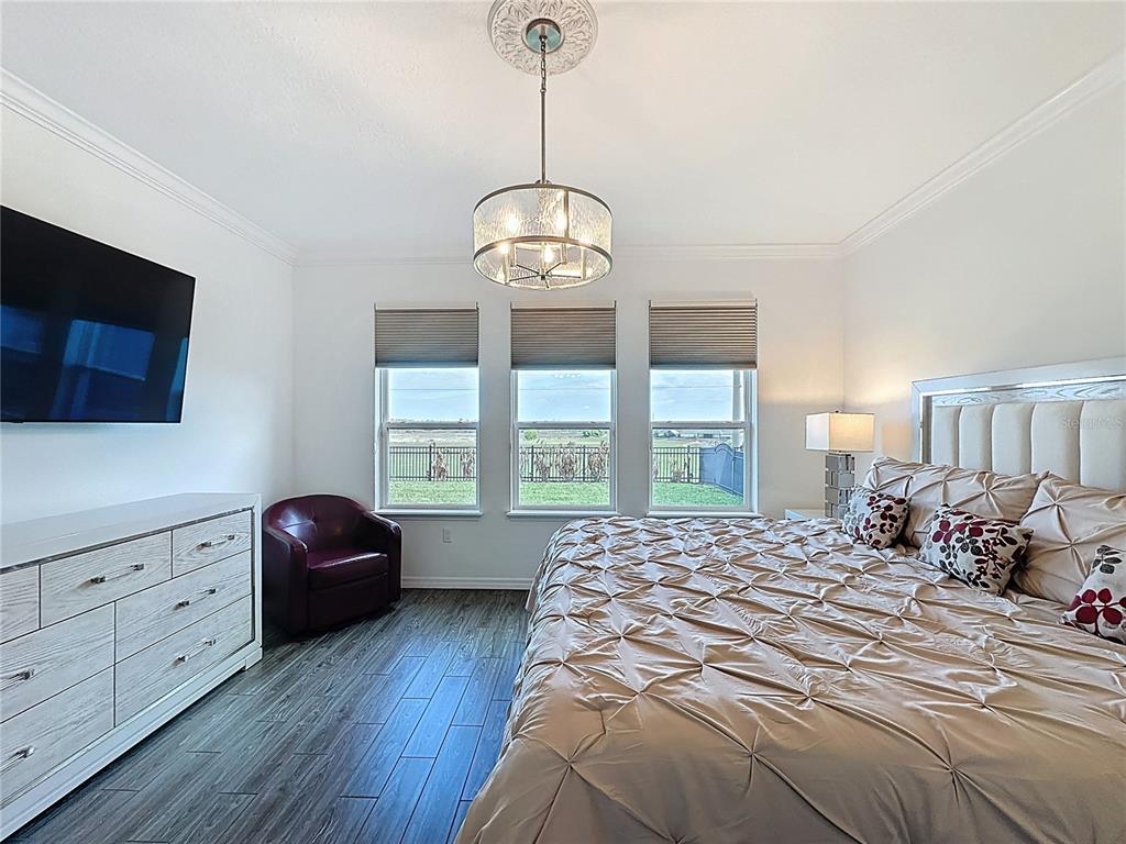 178 Silver Maple Road Groveland, FL 34736 - Photo 28 of 72 a bedroom with a bed and a window