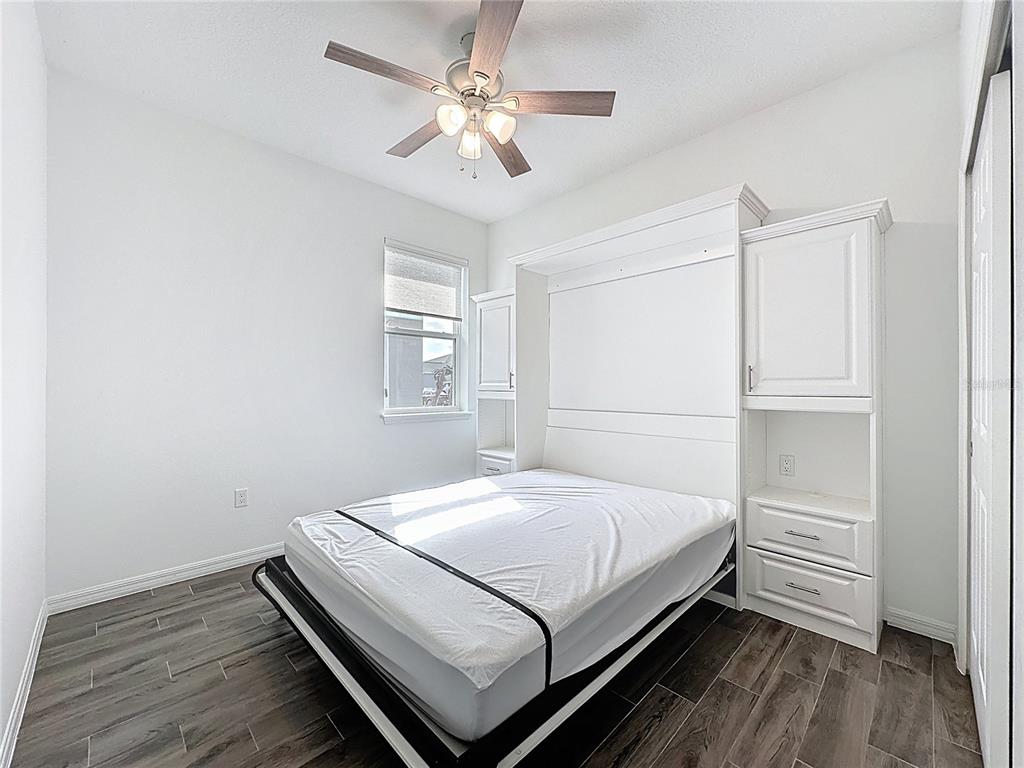 178 Silver Maple Road Groveland, FL 34736 - Photo 29 of 72 a bedroom with a bed and a ceiling fan