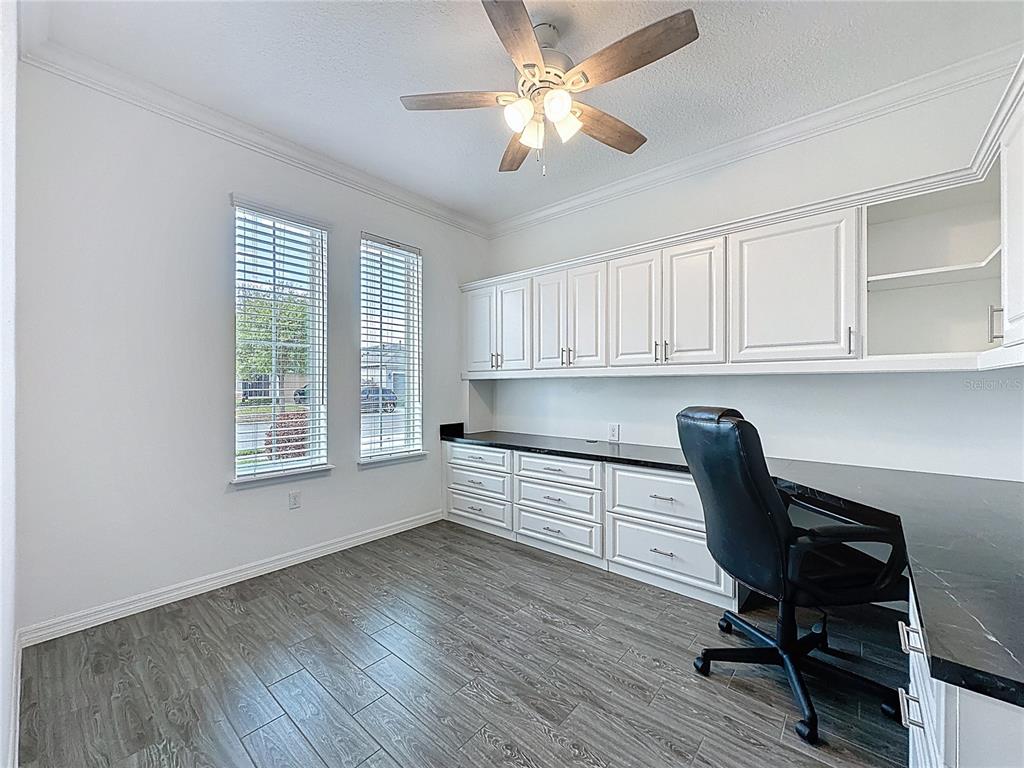 178 Silver Maple Road Groveland, FL 34736 - Photo 30 of 72 a view of a workspace with furniture and a window
