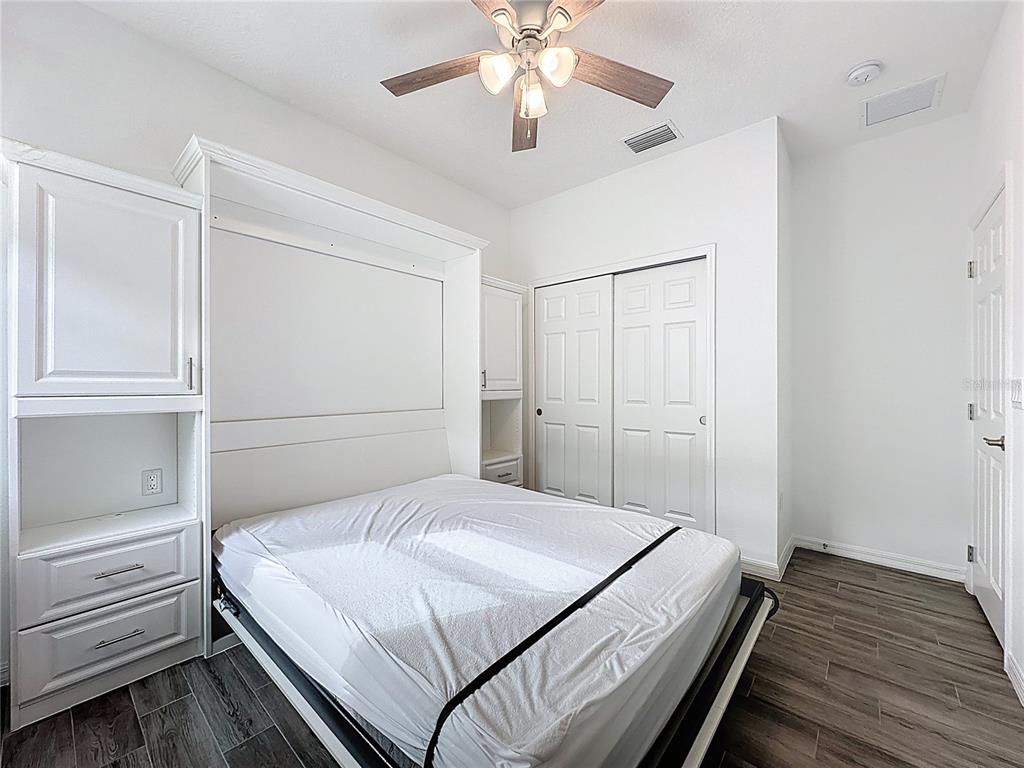 178 Silver Maple Road Groveland, FL 34736 - Photo 33 of 72 a bedroom with a bed and a chandelier