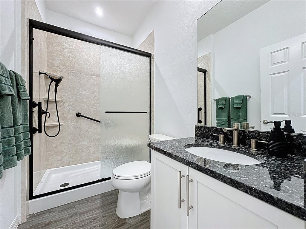 178 Silver Maple Road Groveland, FL 34736 - Photo 35 of 72 a bathroom with a granite countertop sink toilet and shower