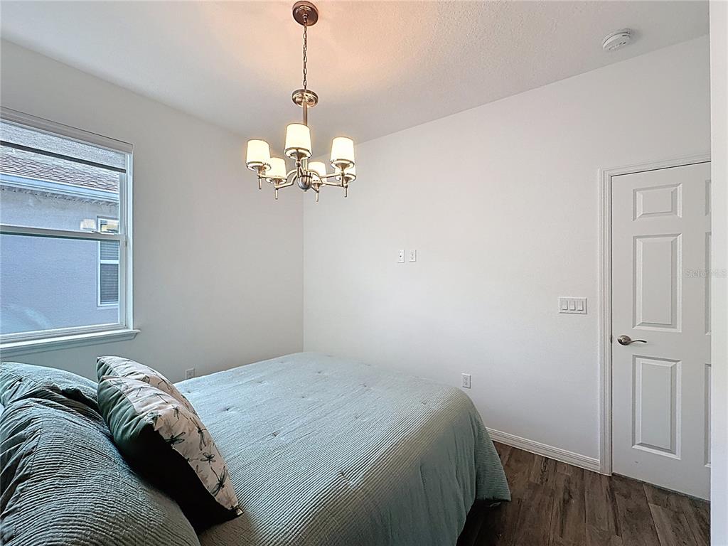 178 Silver Maple Road Groveland, FL 34736 - Photo 37 of 72 a bedroom with a bed and wooden floor