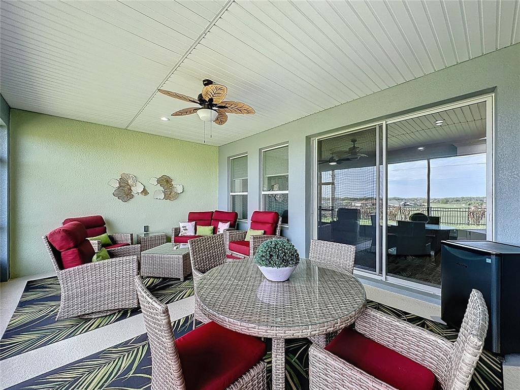 178 Silver Maple Road Groveland, FL 34736 - Photo 39 of 72 a living room with furniture and a floor to ceiling window