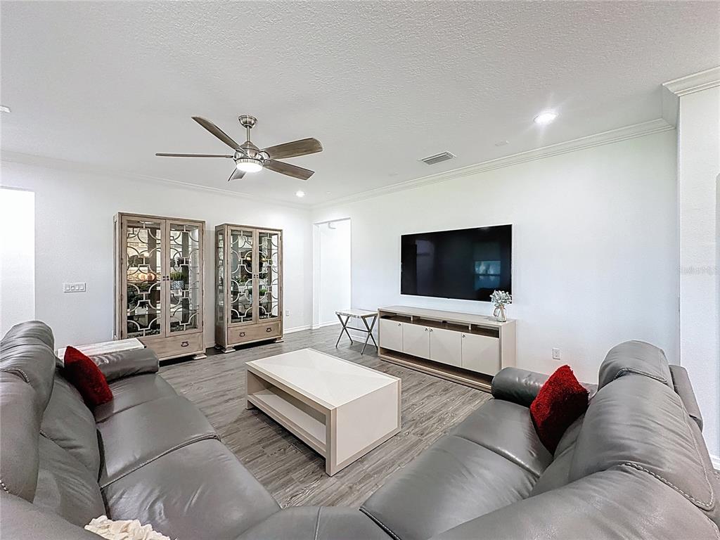 178 Silver Maple Road Groveland, FL 34736 - Photo 6 of 72 a living room with furniture ceiling fan and a window