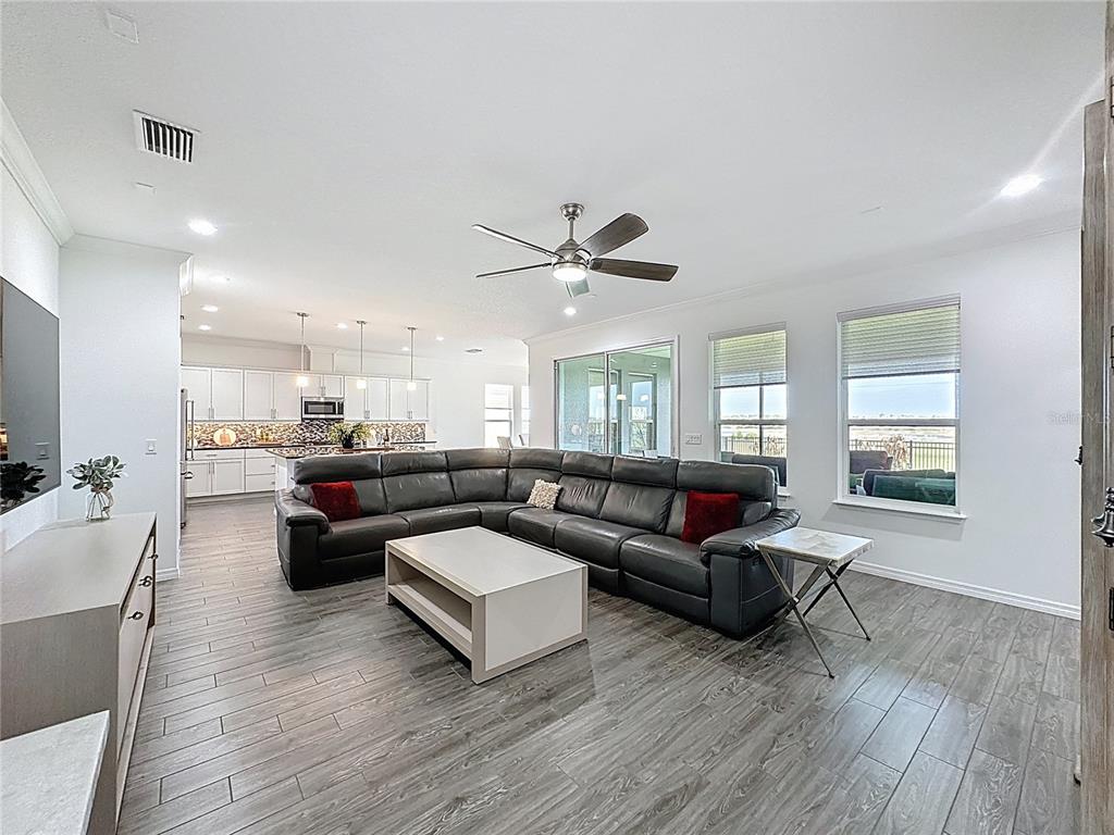 178 Silver Maple Road Groveland, FL 34736 - Photo 9 of 72 a living room with furniture and a wooden floor
